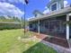 Inviting front porch area with a screened enclosure, seating, and manicured landscaping at 3705 Pine Cir, Lake Wales, FL 33898