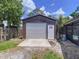 Detached garage or workshop with roll-up door, offering ample space for parking and projects at 3705 Pine Cir, Lake Wales, FL 33898