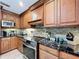 A lovely kitchen featuring stone backsplash, stainless steel appliances, and stunning cabinets and granite countertops at 3705 Pine Cir, Lake Wales, FL 33898