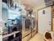 Well-equipped laundry room with modern washer and dryer, shelves and a cat play area at 3705 Pine Cir, Lake Wales, FL 33898