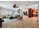Open-concept living room with a tile floor, ceiling fan, and seamless access to the adjacent kitchen at 3705 Pine Cir, Lake Wales, FL 33898