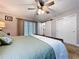 Comfortable main bedroom with a ceiling fan, and ensuite bathroom access through sliding barn door at 3705 Pine Cir, Lake Wales, FL 33898