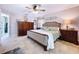 Beautifully furnished main bedroom featuring wood furniture, neutral decor and a tiled floor at 3705 Pine Cir, Lake Wales, FL 33898