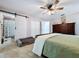 Bright main bedroom with a sliding barn door to the bathroom and a ceiling fan for added comfort at 3705 Pine Cir, Lake Wales, FL 33898