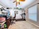 Bright office space with built in shelving, large screen monitor, ceiling fan and a treadmill at 3705 Pine Cir, Lake Wales, FL 33898