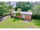 Outbuilding with wooden siding, multiple doors, and a metal roof surrounded by lush lawn at 3705 Pine Cir, Lake Wales, FL 33898