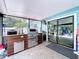 Outdoor Kitchen with stainless steel BBQ and an enclosed view of the outdoor seating area at 3705 Pine Cir, Lake Wales, FL 33898