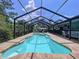 Beautiful screened-in pool surrounded by brick pavers, perfect for relaxation and entertainment at 3705 Pine Cir, Lake Wales, FL 33898