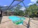 Enclosed pool with lounging float, surrounded by brick pavers, offering a tranquil escape at 3705 Pine Cir, Lake Wales, FL 33898