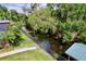 Overhead view of a lush backyard leading to a serene waterway, offering a picturesque setting at 3705 Pine Cir, Lake Wales, FL 33898
