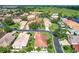 Neighborhood aerial view features mature trees, ponds, and single Gathering homes at 380 Niblick Cir, Winter Haven, FL 33881