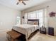 Serene bedroom with a queen bed, wooden headboard, and neutral decor creating a relaxing atmosphere at 380 Niblick Cir, Winter Haven, FL 33881