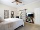Cozy bedroom with a queen bed, TV, and sliding barn door to the bathroom, creating a private retreat at 380 Niblick Cir, Winter Haven, FL 33881
