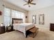 Bright and inviting bedroom with carpeted floors and large window allowing natural light to illuminate the room at 380 Niblick Cir, Winter Haven, FL 33881