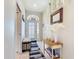 Stylish entryway with tiled floors, a bench, and tasteful decor at 380 Niblick Cir, Winter Haven, FL 33881
