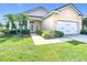 Charming single-story home with a well-manicured lawn and lush landscaping at 380 Niblick Cir, Winter Haven, FL 33881