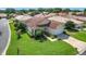 Charming single-story home boasts a well-manicured lawn and attached two-car garage at 380 Niblick Cir, Winter Haven, FL 33881