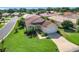 Charming single-story home boasts a well-manicured lawn and attached two-car garage at 380 Niblick Cir, Winter Haven, FL 33881