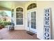 Inviting front porch with brick flooring and charming decor at 380 Niblick Cir, Winter Haven, FL 33881