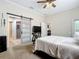 A comfortable main bedroom with ensuite bath featuring a sliding barn door and plush carpet flooring at 380 Niblick Cir, Winter Haven, FL 33881