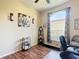 Brightly lit home office featuring wood laminate floors and comfortable seating at 380 Niblick Cir, Winter Haven, FL 33881