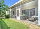 Enclosed patio with views of lush greenery, providing a serene outdoor retreat at 380 Niblick Cir, Winter Haven, FL 33881