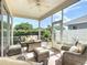 Inviting screened patio features comfortable seating and a ceiling fan for enjoying the outdoors at 380 Niblick Cir, Winter Haven, FL 33881
