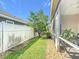 Landscaped yard featuring green grass and decorative stones outside the screened patio at 380 Niblick Cir, Winter Haven, FL 33881