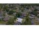 Aerial view of a well-maintained home nestled among mature trees in a quiet residential neighborhood at 40 Westridge Rd, Davenport, FL 33837
