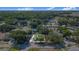 Aerial view of a well-maintained home nestled among mature trees in a quiet residential neighborhood at 40 Westridge Rd, Davenport, FL 33837
