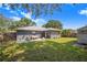 Lush backyard featuring a patio area, mature trees, and ample space for recreation and outdoor enjoyment at 40 Westridge Rd, Davenport, FL 33837