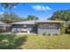 Spacious backyard with a patio, lush lawn, and mature landscaping provides a private outdoor retreat at 40 Westridge Rd, Davenport, FL 33837