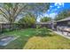 Large backyard with lush lawn, mature trees, and a patio area, ideal for outdoor entertaining and relaxation at 40 Westridge Rd, Davenport, FL 33837