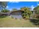 Well-manicured backyard with patio, lush lawn, and established plants offers a serene outdoor living space at 40 Westridge Rd, Davenport, FL 33837