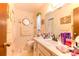 Well-lit bathroom with a large mirror, vanity with sink, and coastal themed decor at 40 Westridge Rd, Davenport, FL 33837