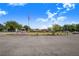 Edgehill Community Center and the American flag are featured under a bright blue, partly cloudy sky at 40 Westridge Rd, Davenport, FL 33837