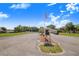 Welcoming community entrance featuring an American flag, building, and parking for residents and visitors at 40 Westridge Rd, Davenport, FL 33837
