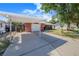Long driveway leading to a brick home with a convenient carport for covered parking and protection from the elements at 40 Westridge Rd, Davenport, FL 33837