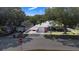Charming single-story home with a covered carport, well-maintained lawn, and mature trees providing shade at 40 Westridge Rd, Davenport, FL 33837