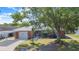Charming brick home featuring well-maintained front yard and a convenient carport for covered parking at 40 Westridge Rd, Davenport, FL 33837