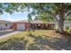 Charming brick home with a well-manicured front yard and mature shade trees, offering curb appeal at 40 Westridge Rd, Davenport, FL 33837