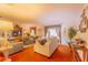 Comfortable living room featuring plush seating, carpet, and a large window for ample natural light at 40 Westridge Rd, Davenport, FL 33837