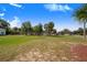 Spacious green park area featuring gazebos and a variety of lush trees under a bright blue, partly cloudy sky at 40 Westridge Rd, Davenport, FL 33837