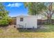 Exterior view of a functional storage shed in the backyard, providing practical space for tools and equipment at 40 Westridge Rd, Davenport, FL 33837