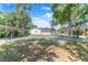 Well-maintained tennis courts with covered seating areas, surrounded by trees providing shade and comfort for players at 40 Westridge Rd, Davenport, FL 33837
