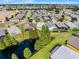 An aerial view showcasing the property's location, surrounded by lush greenery and a serene pond at 4100 Martindale Loop, Winter Haven, FL 33884