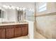 Well-lit bathroom showcases a double sink vanity and glass-enclosed shower at 4100 Martindale Loop, Winter Haven, FL 33884