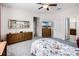Well-lit bedroom with view of dressers, TV and entry to bathroom at 4100 Martindale Loop, Winter Haven, FL 33884