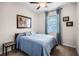 Relaxing bedroom with blue comforter and ample natural light at 4100 Martindale Loop, Winter Haven, FL 33884