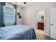 Bright bedroom with entry to bathroom, a blue comforter and carpet at 4100 Martindale Loop, Winter Haven, FL 33884